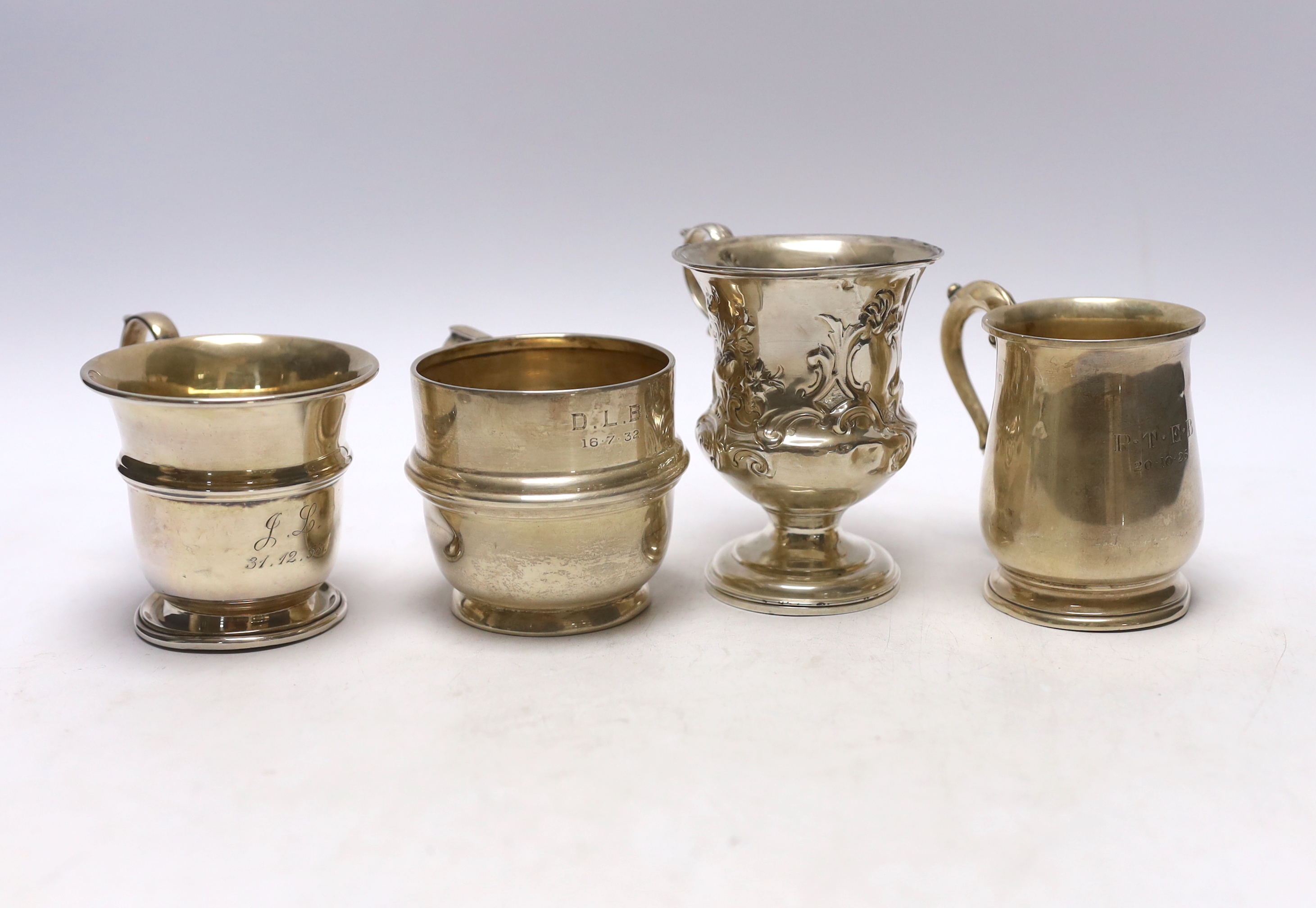 An early Victorian repousse silver pedestal christening mug, Charles Fox, London, 1839, 95mm and three later silver christening mugs, 10.7oz.